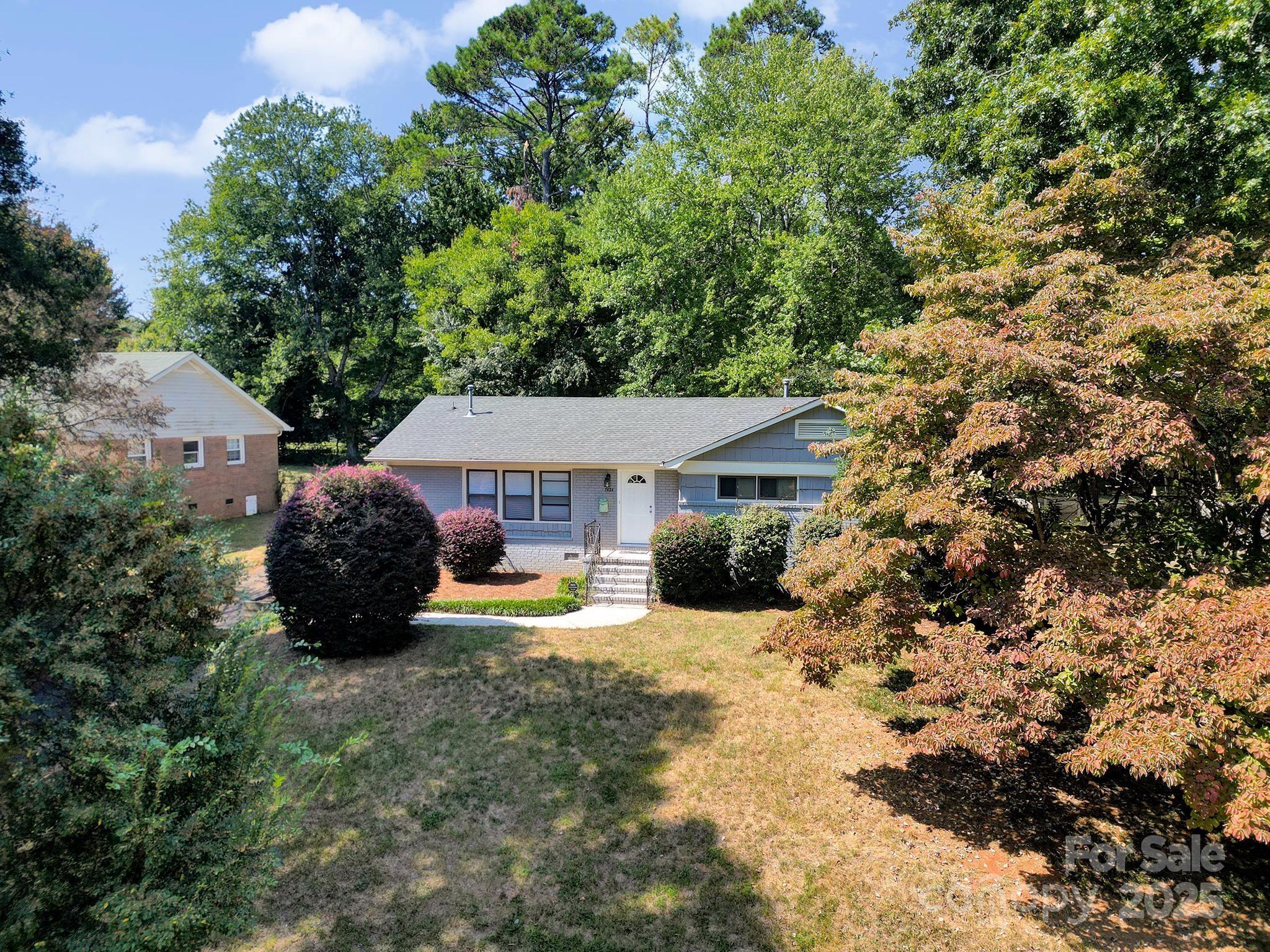 7424 Watercrest Road Charlotte, NC 28210 - Photo 28 of 32 a view of a house with a yard and sitting area