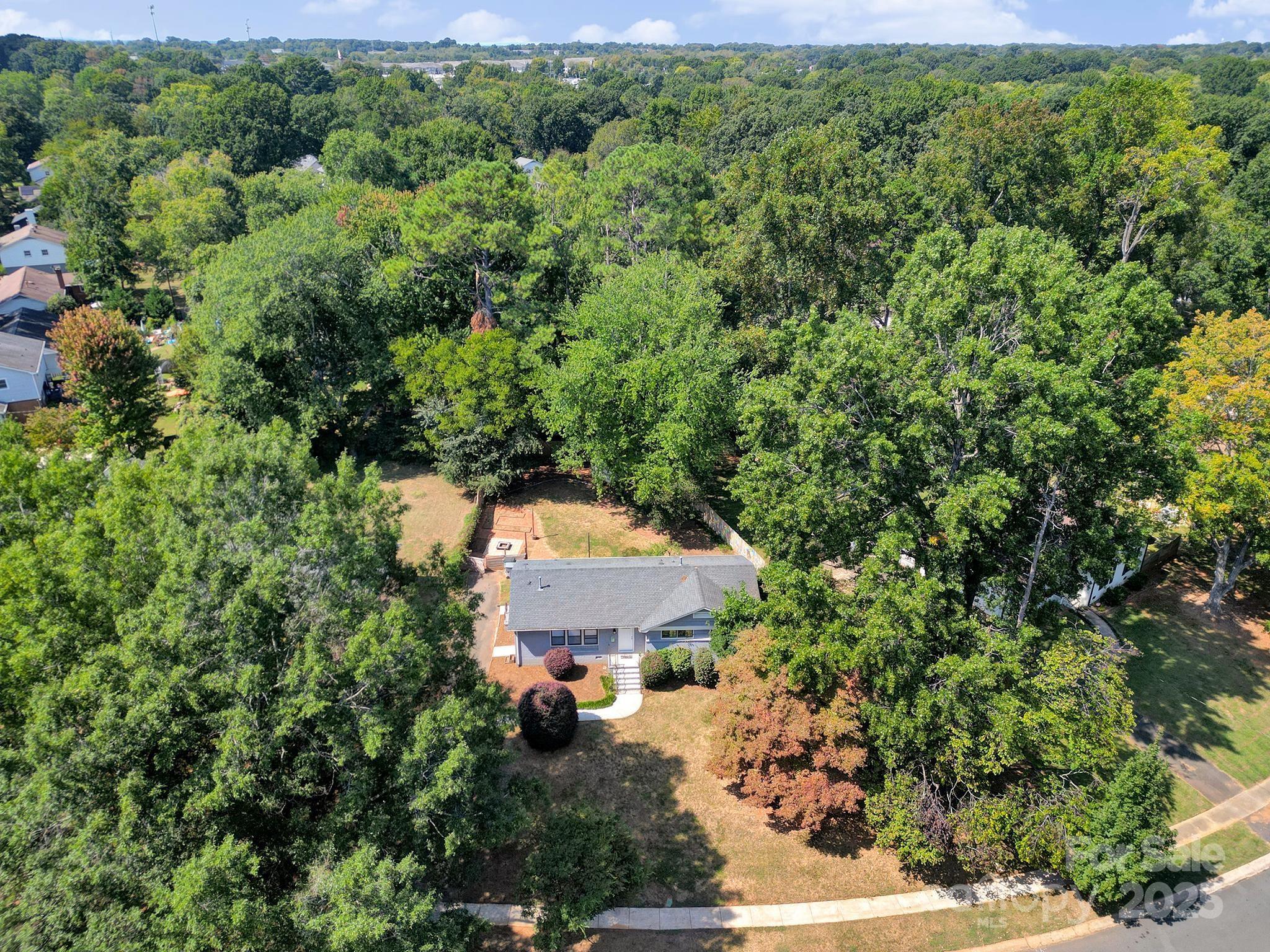 7424 Watercrest Road Charlotte, NC 28210 - Photo 30 of 32 an aerial view of a house with a yard and outdoor seating