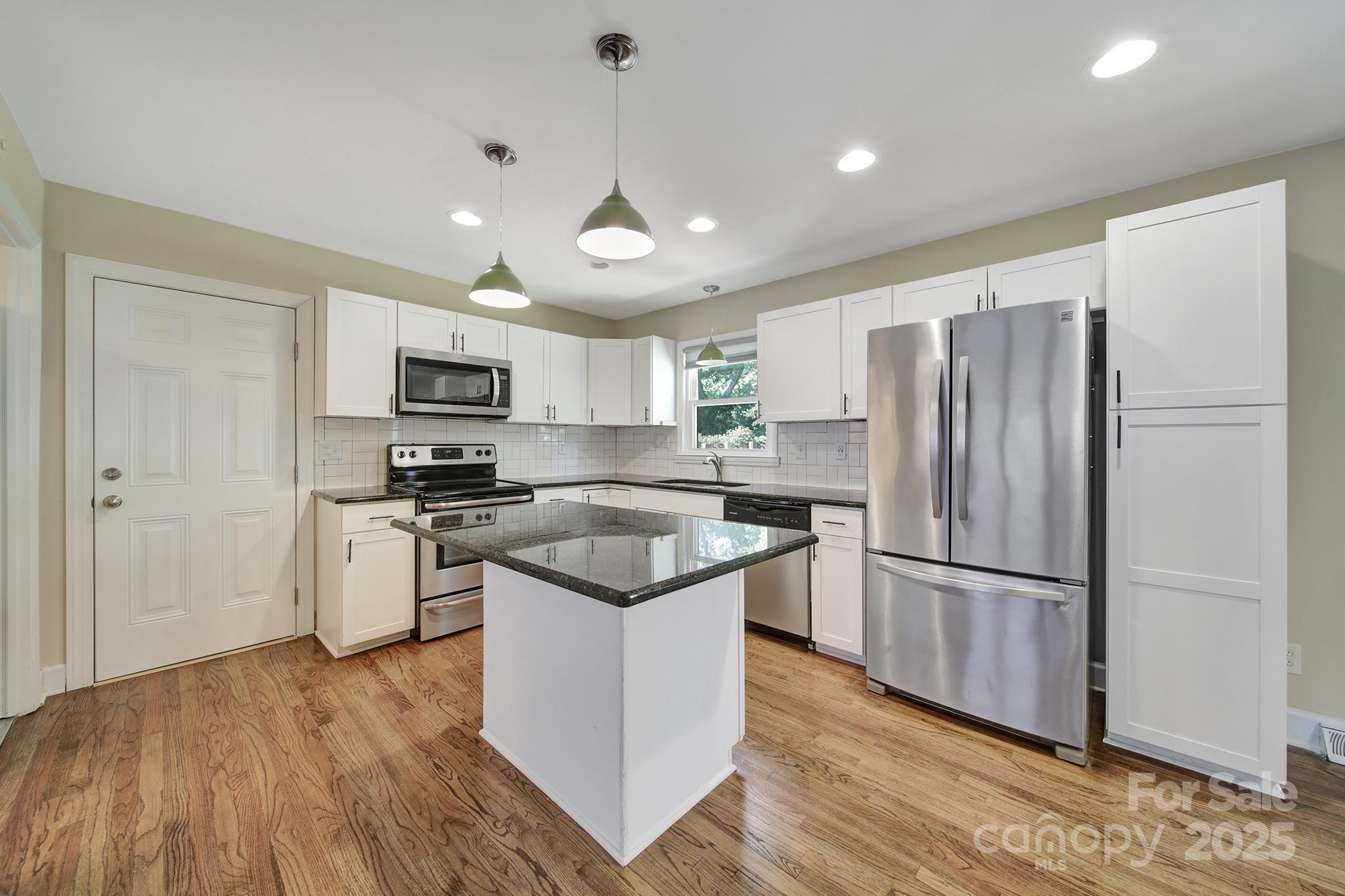 7424 Watercrest Road Charlotte, NC 28210 - Photo 9 of 32 a kitchen with a refrigerator a sink and a microwave