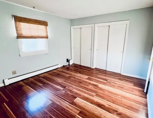 a view of a room with wooden floor and closet