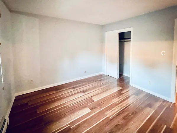a view of a room with wooden floor