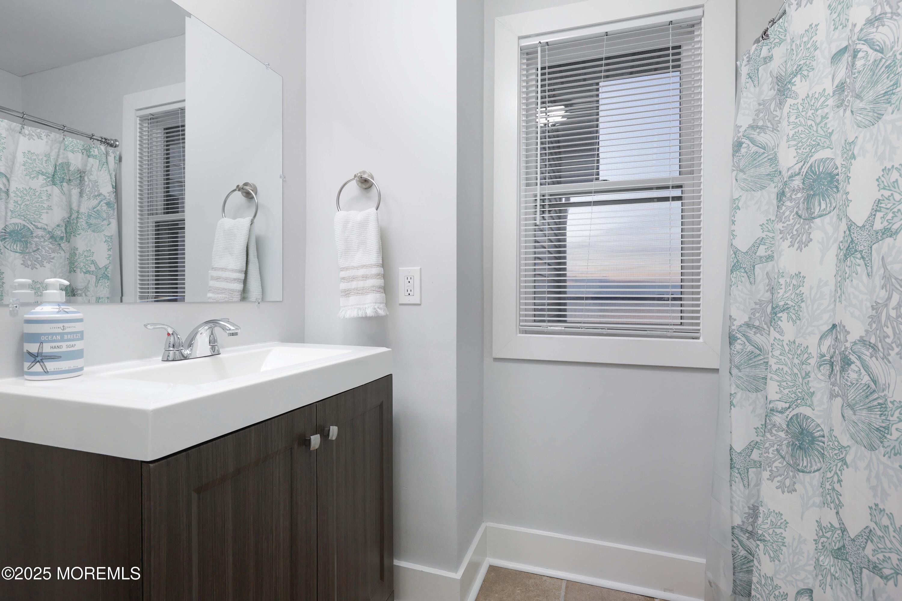 151 Shore Drive Brick, NJ 08723 - Photo 16 of 40 a bathroom with a sink and a mirror
