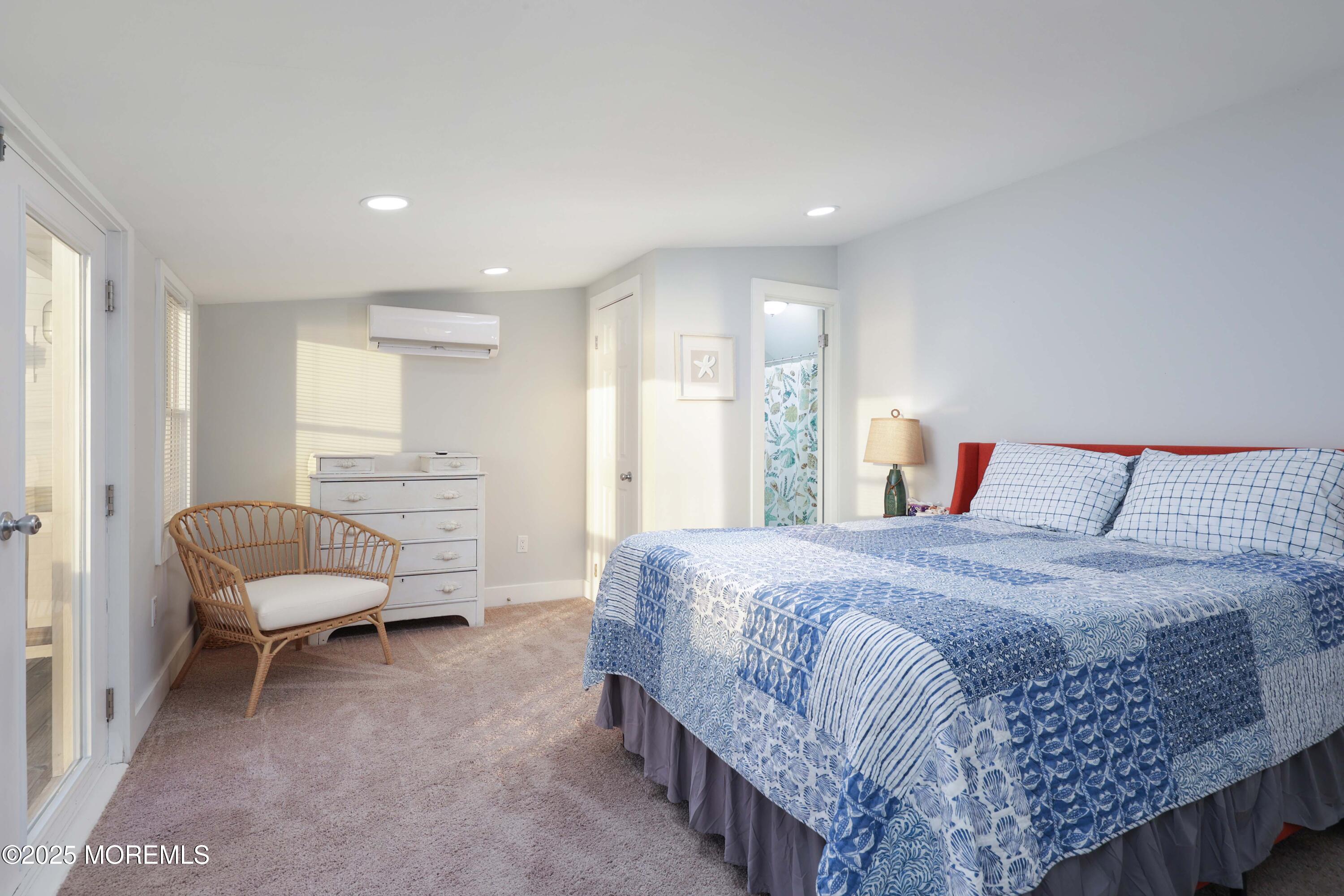 151 Shore Drive Brick, NJ 08723 - Photo 21 of 40 a spacious bedroom with a bed and a chair