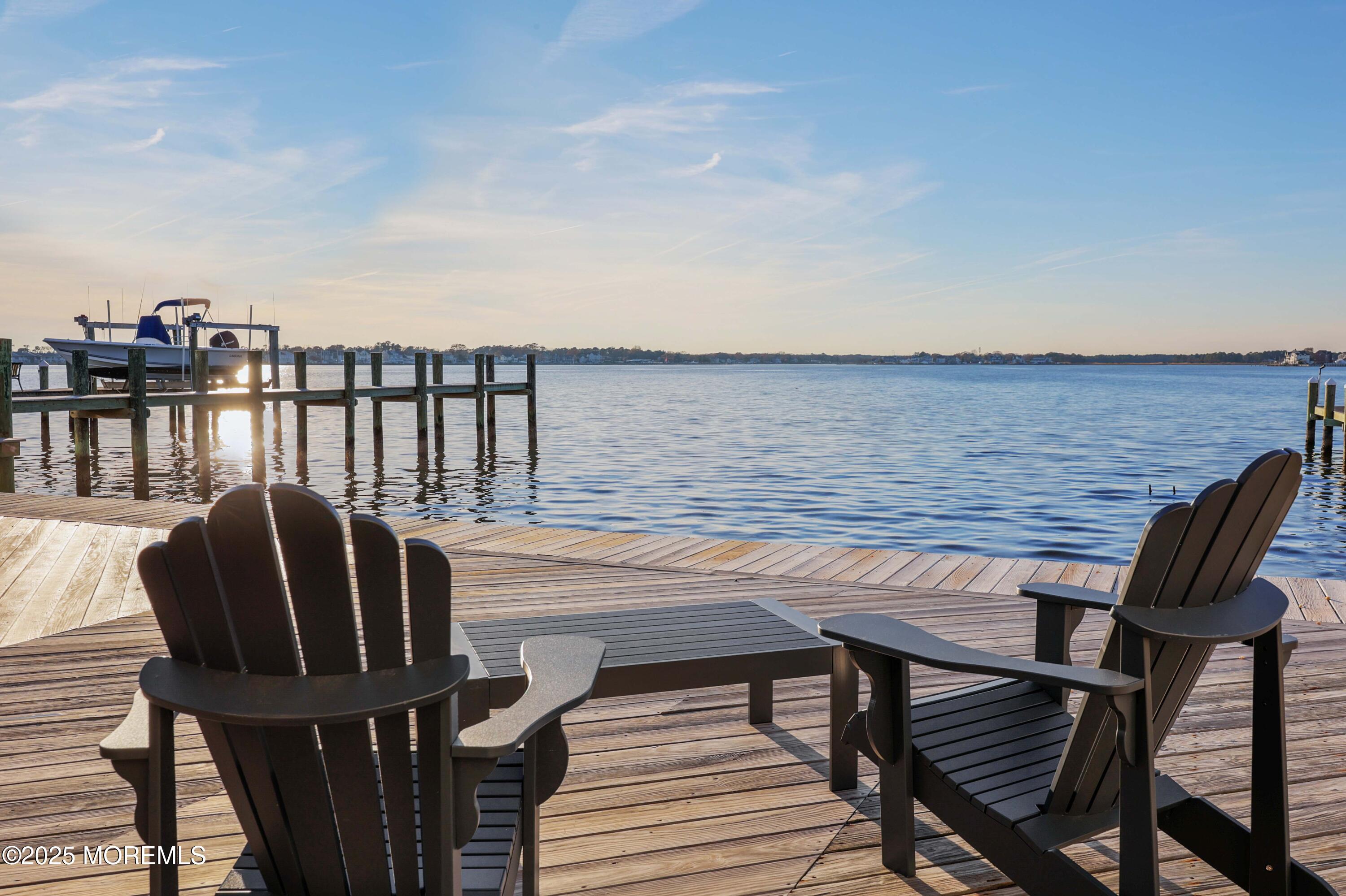 151 Shore Drive Brick, NJ 08723 - Photo 5 of 40 a balcony with wooden floor table and chairs