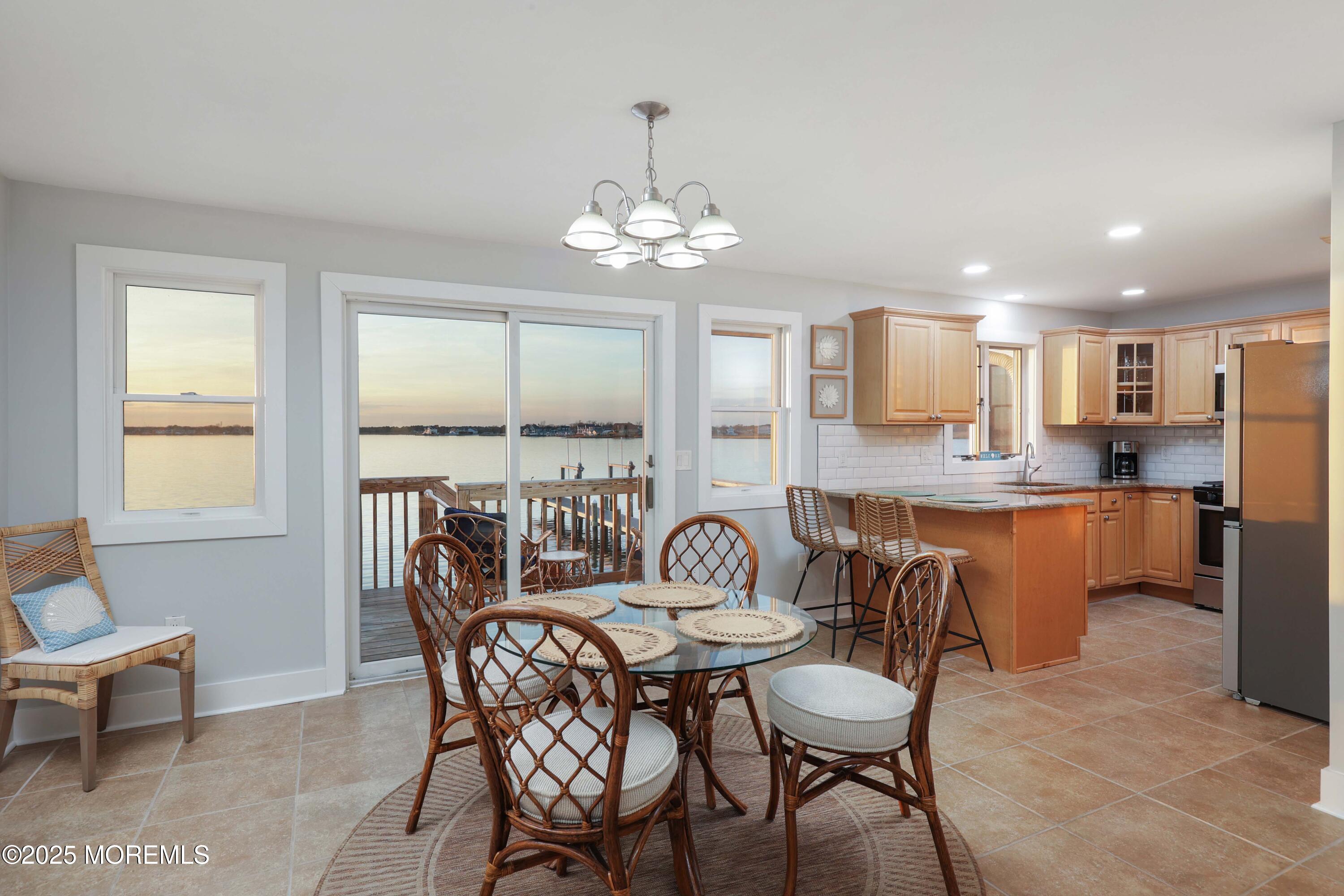 151 Shore Drive Brick, NJ 08723 - Photo 9 of 40 a view of a dining room with furniture a chandelier and wooden floor
