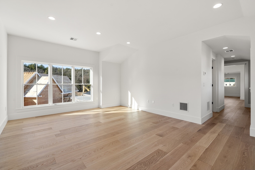 1060 Grove Street, Unit LOT 43 Framingham, MA 01701 - Photo 11 of 15 a view of an empty room with wooden floor and a window