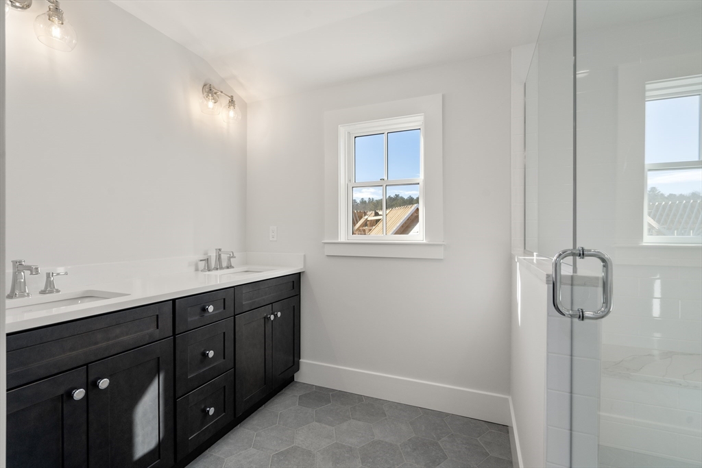 1060 Grove Street, Unit LOT 43 Framingham, MA 01701 - Photo 12 of 15 a spacious bathroom with a double vanity sink and a mirror