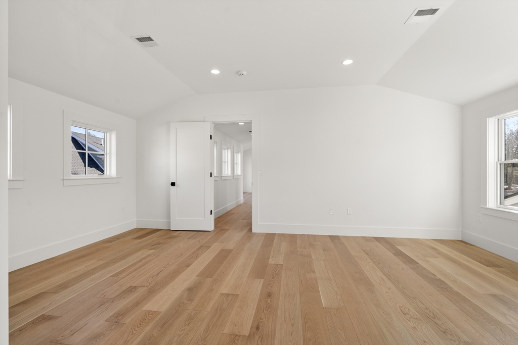 1060 Grove Street, Unit LOT 43 Framingham, MA 01701 - Photo 8 of 15 a view of an empty room with wooden floor and a window