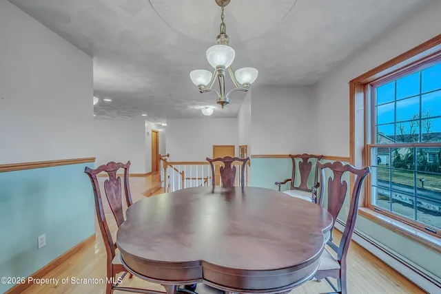 a dining room with furniture a rug and wooden floor