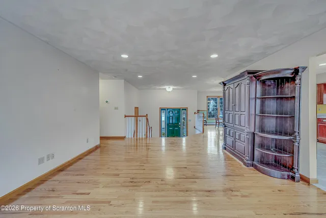 a view of empty room with wooden floor and cabinet