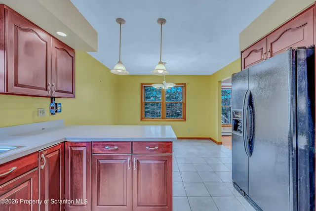 a kitchen with a refrigerator and cabinets