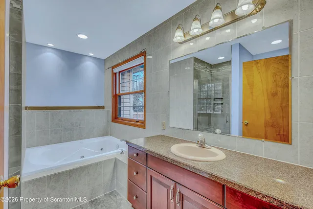 a bathroom with a tub and shower