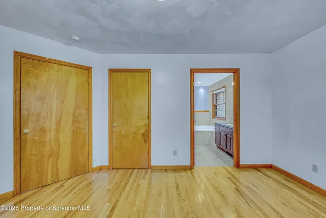 a view of room with window and wooden floor