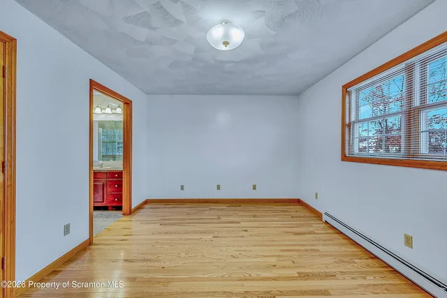 a view of a room with a wooden floor and a window