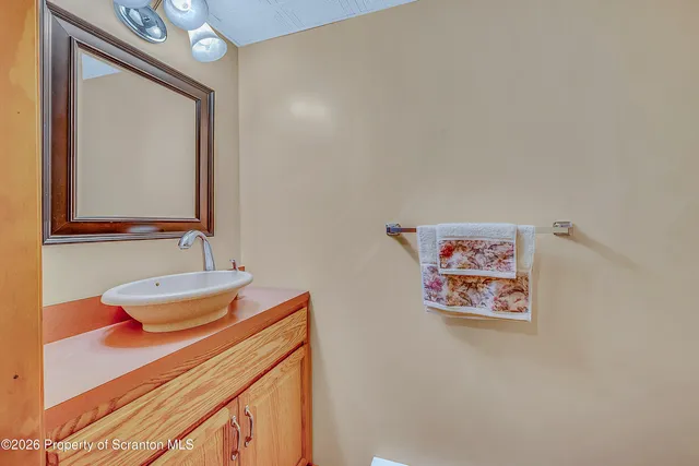 a bathroom with a toilet a sink and a mirror