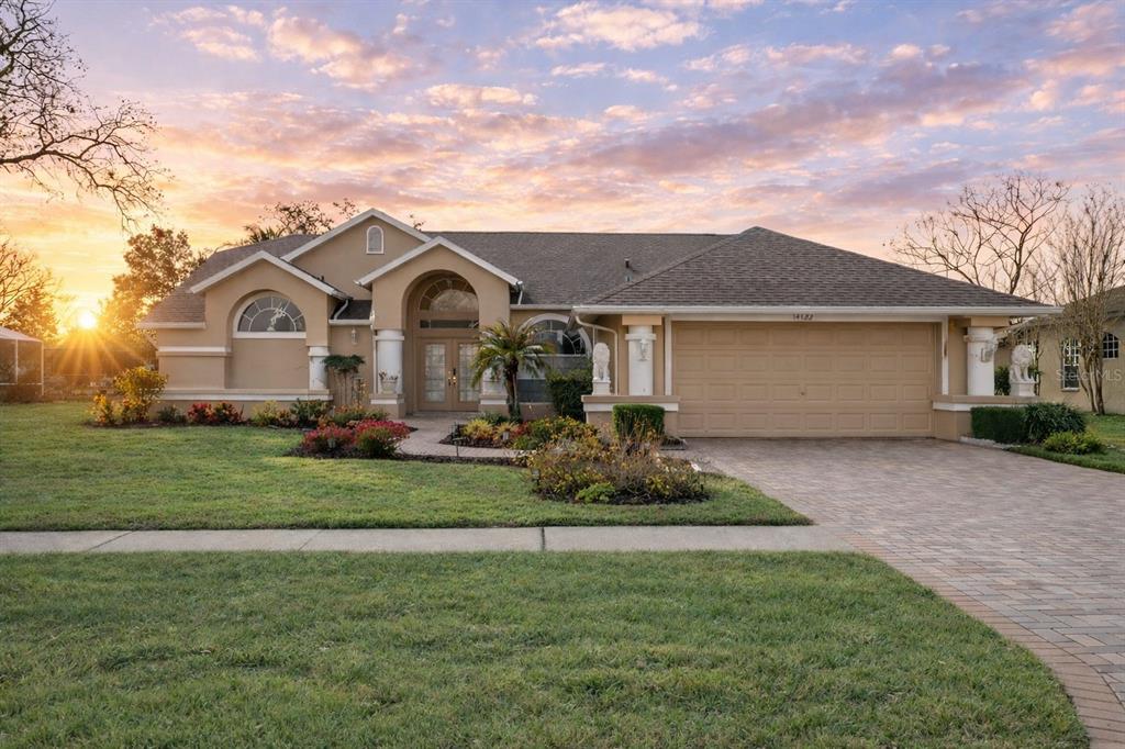 a front view of a house with a garden