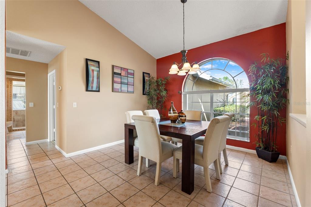 14122 Newcastle Avenue Spring Hill, FL 34609 - Photo 15 of 66 a view of a dining room with furniture and chandelier