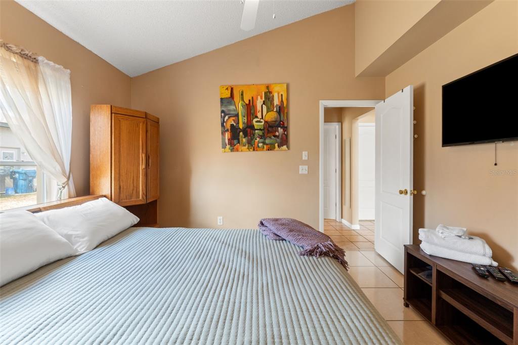14122 Newcastle Avenue Spring Hill, FL 34609 - Photo 36 of 66 a bedroom with a bed and a flat screen tv