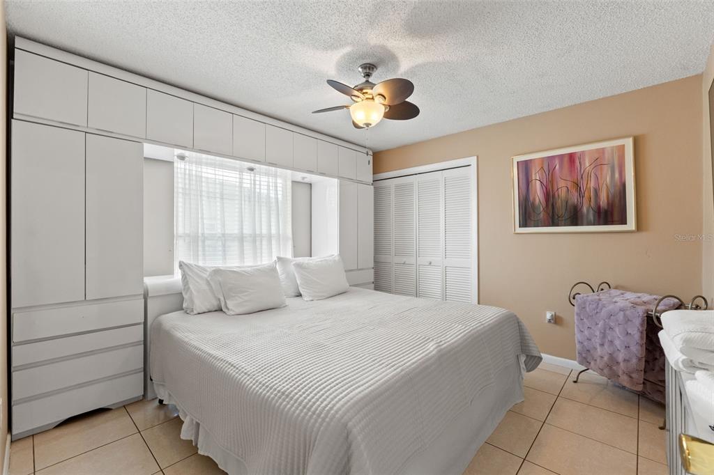 14122 Newcastle Avenue Spring Hill, FL 34609 - Photo 38 of 66 a bedroom with a bed and a chandelier