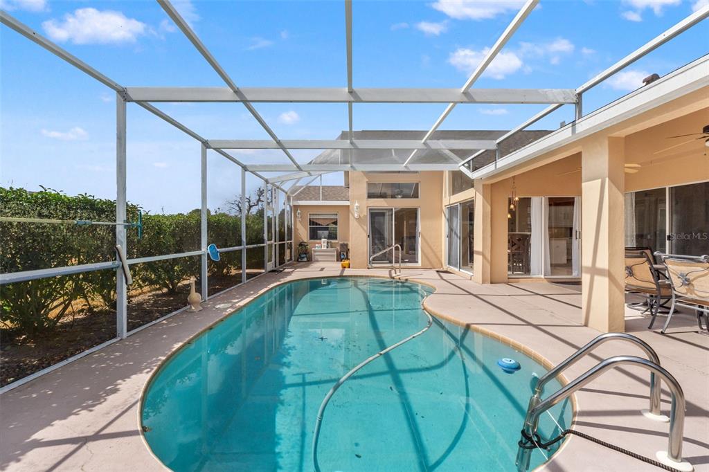 14122 Newcastle Avenue Spring Hill, FL 34609 - Photo 54 of 66 a view of a swimming pool with a patio