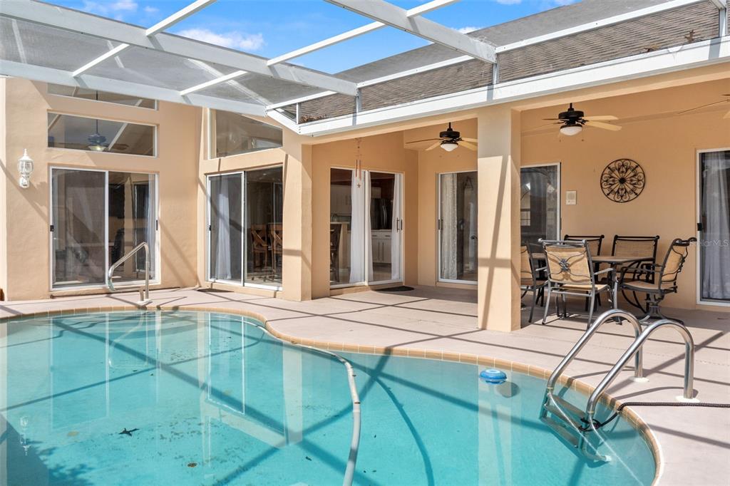 14122 Newcastle Avenue Spring Hill, FL 34609 - Photo 55 of 66 a view of a house with backyard porch and glass door