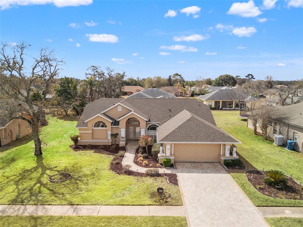 14122 Newcastle Avenue Spring Hill, FL 34609 - Photo 6 of 66 a view of a big house with a big yard and large tree