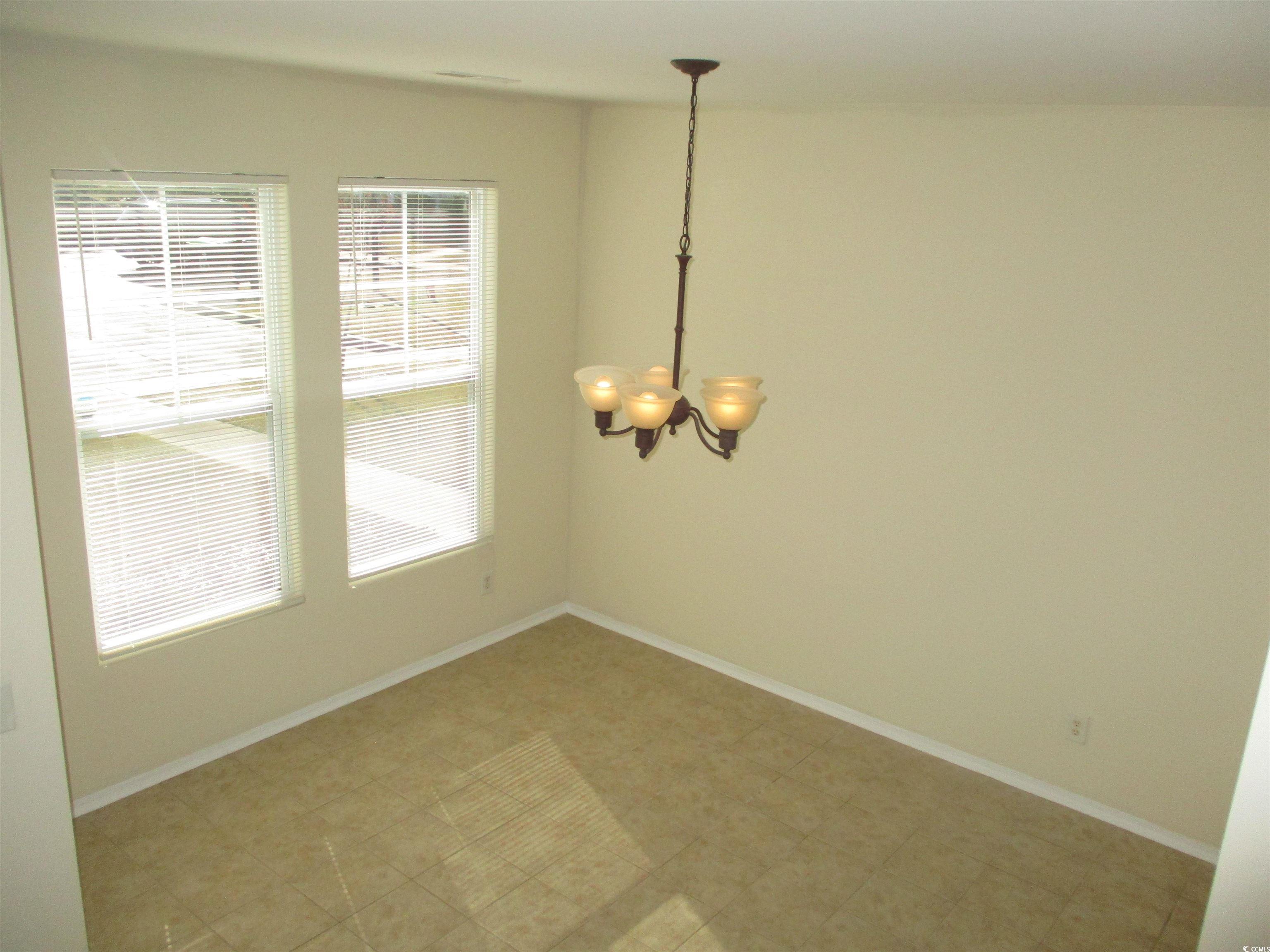 161 Olde Towne Way Myrtle Beach, SC 29588 - Photo 13 of 25 Unfurnished dining area with baseboards and a chandelier