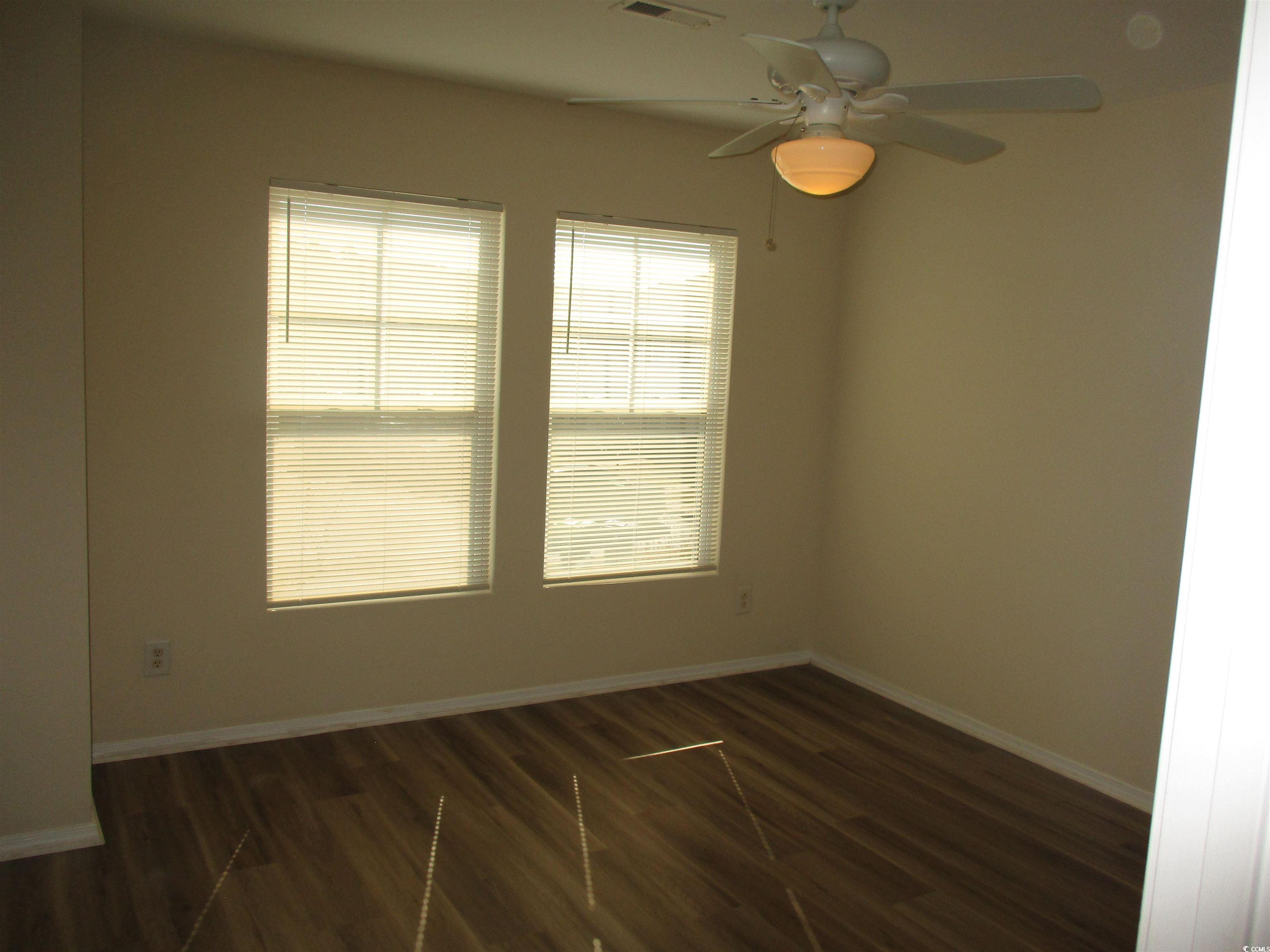 161 Olde Towne Way Myrtle Beach, SC 29588 - Photo 20 of 25 Spare room featuring dark wood-type flooring and ceiling fan