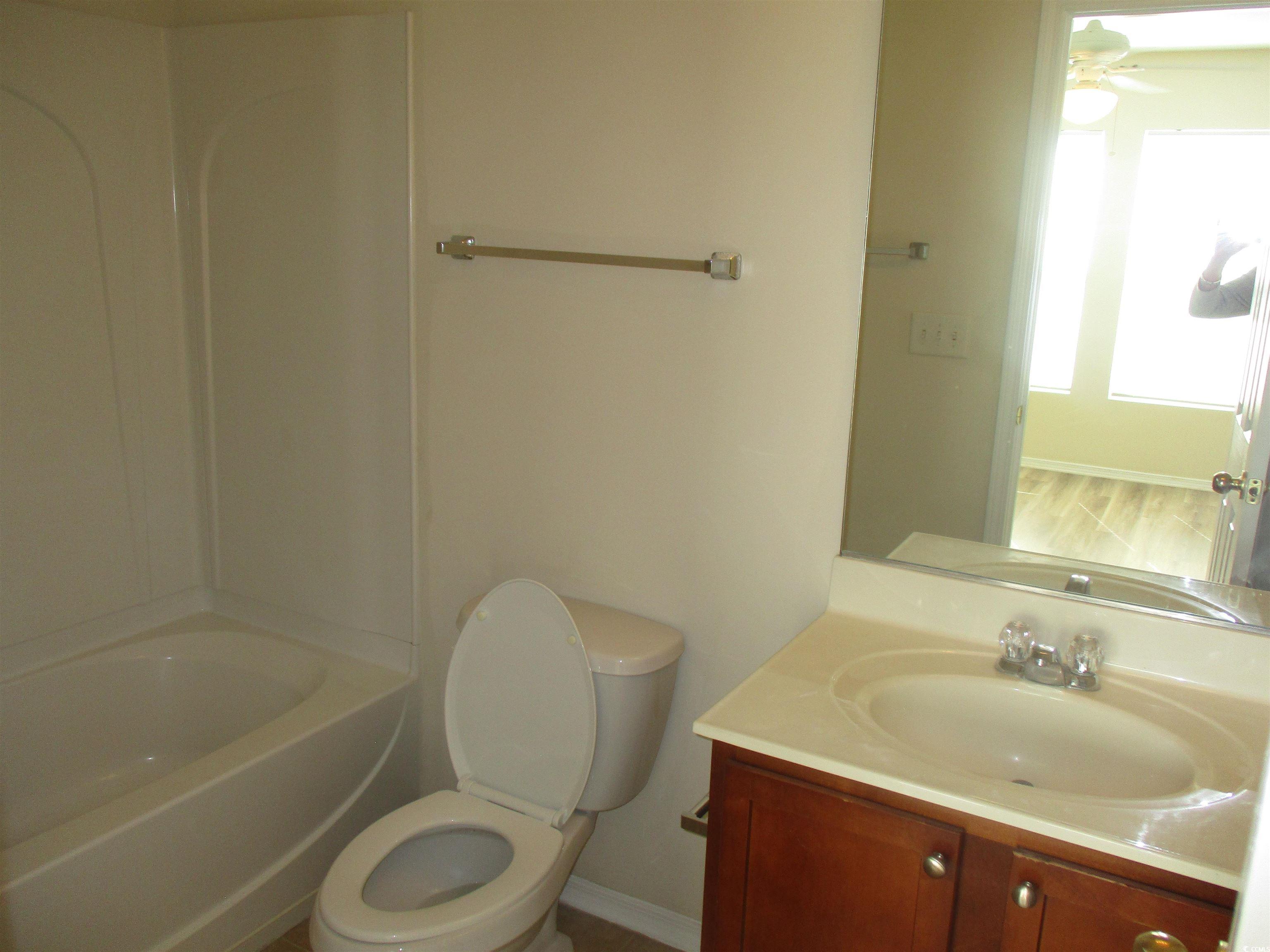161 Olde Towne Way Myrtle Beach, SC 29588 - Photo 22 of 25 Full bathroom with vanity, bathing tub / shower combination, and a ceiling fan