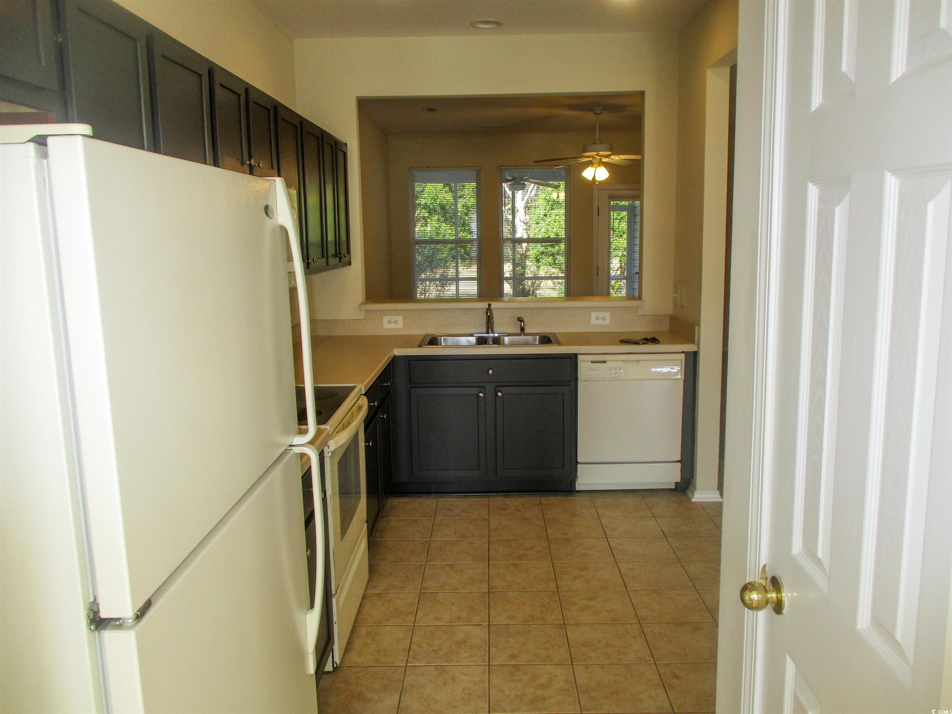 161 Olde Towne Way Myrtle Beach, SC 29588 - Photo 3 of 25 Kitchen featuring white appliances, light tile patterned floors, light countertops, and recessed lighting