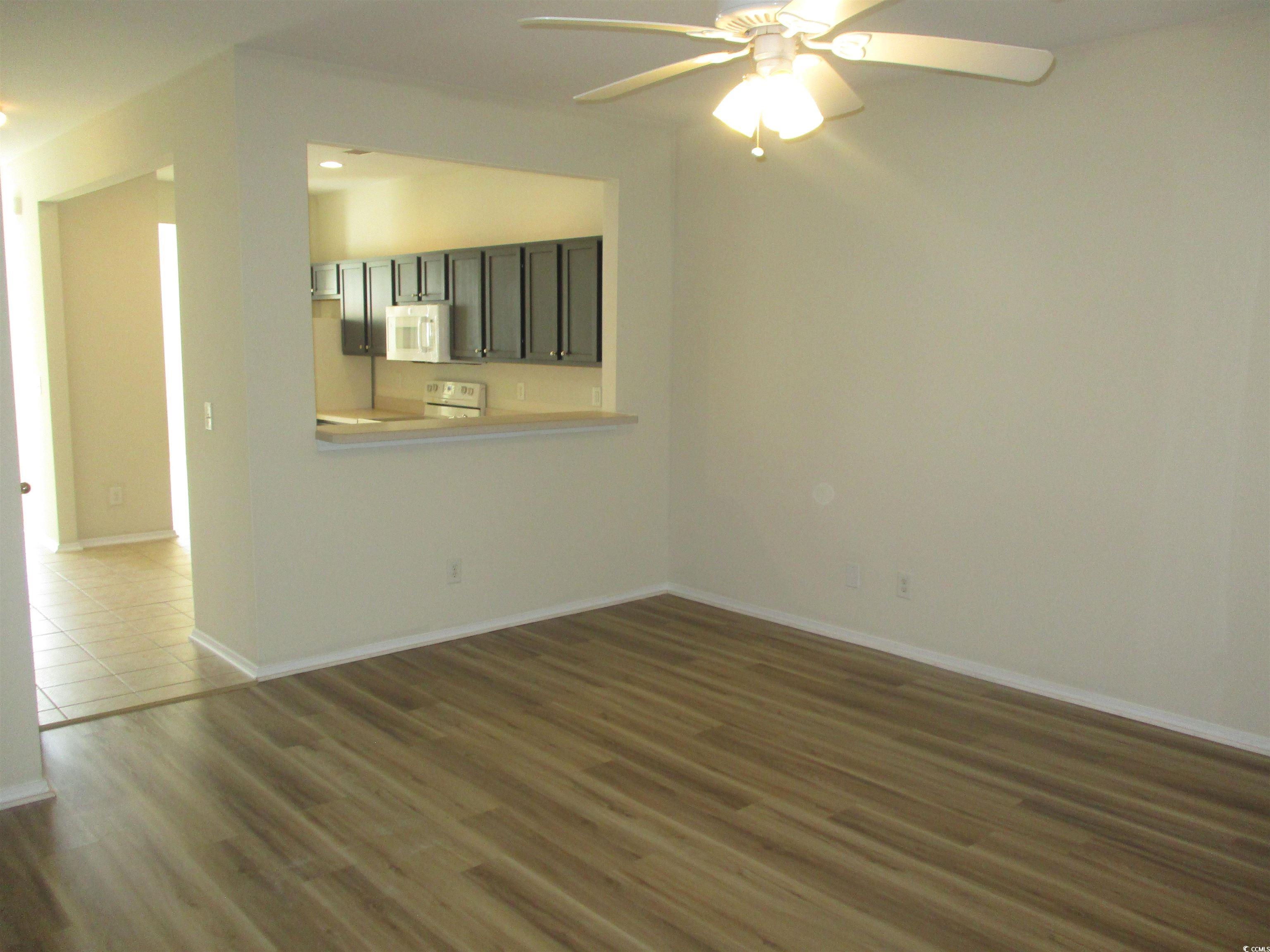 161 Olde Towne Way Myrtle Beach, SC 29588 - Photo 6 of 25 Unfurnished room with dark wood-style floors and ceiling fan
