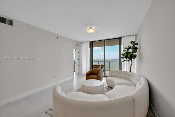 a living room with furniture and a potted plant