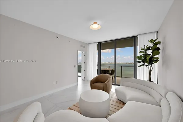 a living room with furniture and a large window