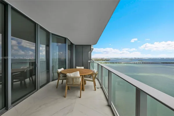 a balcony with table and chairs