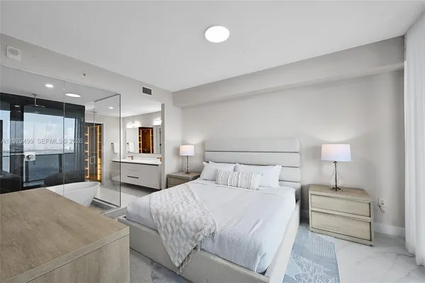 a bedroom with a bed and a lamp