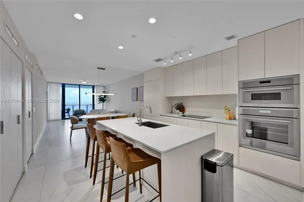 a kitchen with a stove a sink and a refrigerator