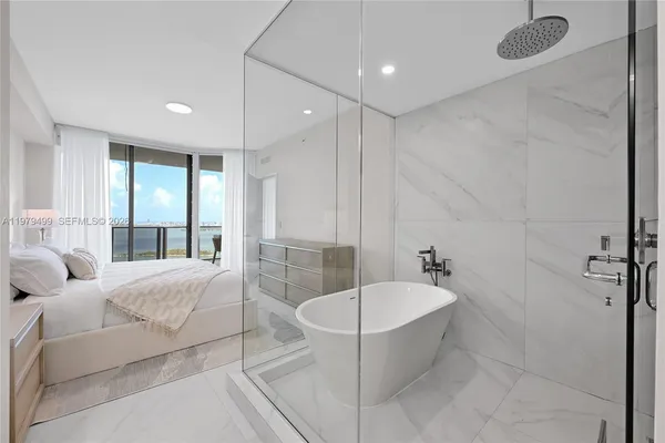 a spacious bathroom with a bathtub and shower