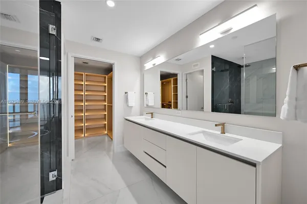 a bathroom with a double vanity sink and a mirror