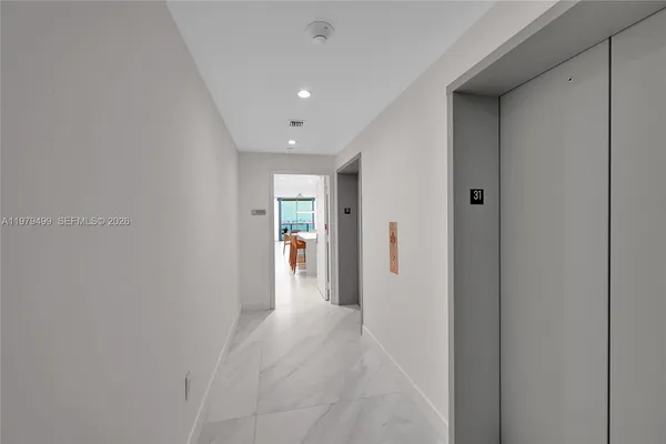 a view of a hallway with wooden shelves