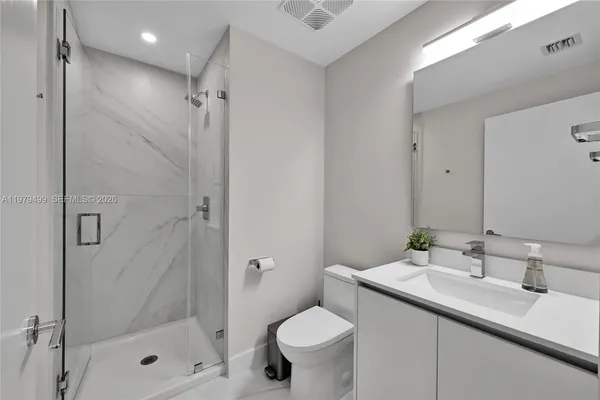 a bathroom with a sink toilet and shower