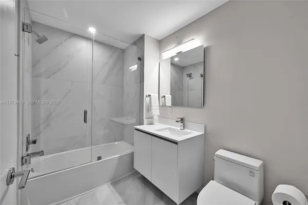 a bathroom with a toilet sink and shower