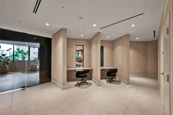 a view of a lobby with gym equipment and floor to ceiling window