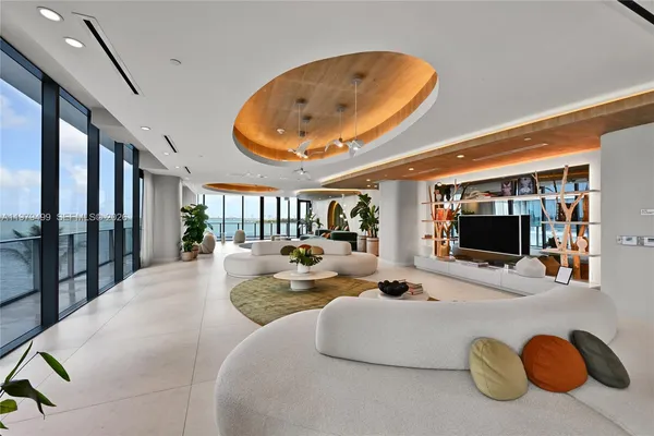 a bedroom with bed and glass windows