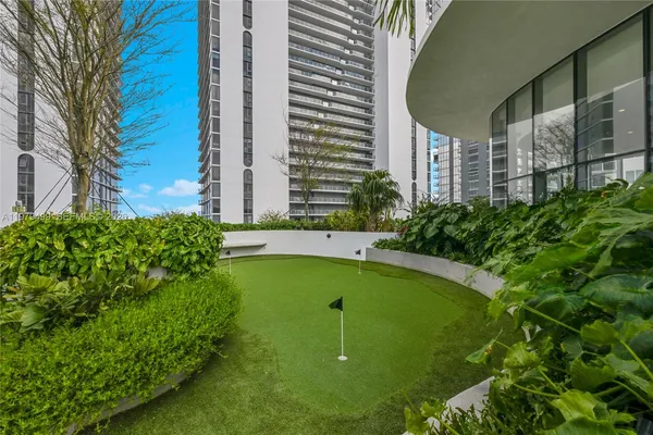a view of a swimming pool with a yard