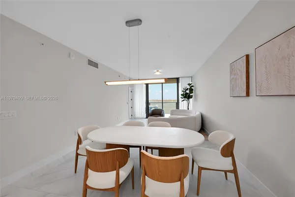 a view of a dining room with furniture and window