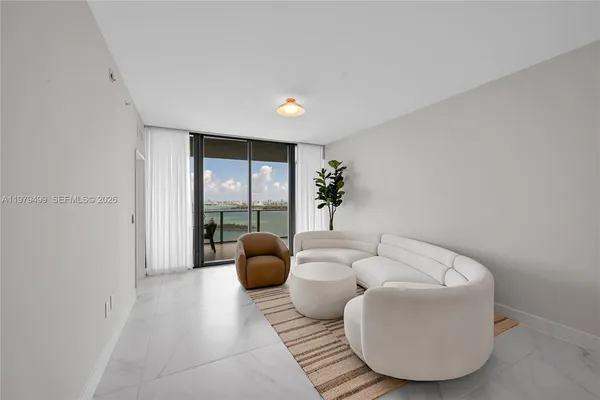 a living room with furniture and a potted plant