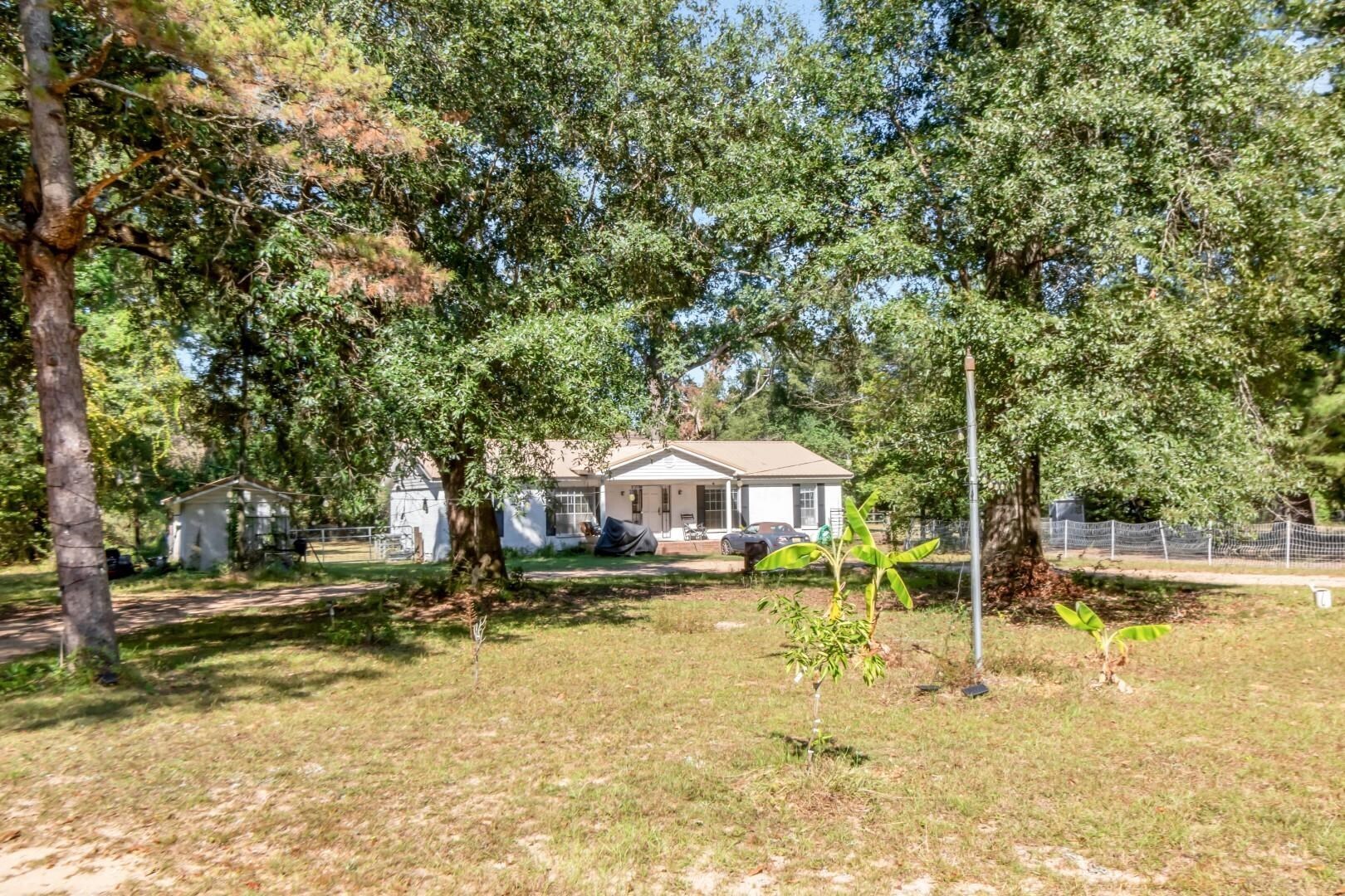 6405 1st Street Wilmer, AL 36587 - Photo 25 of 38 View of yard featuring a patio and view of scattered trees