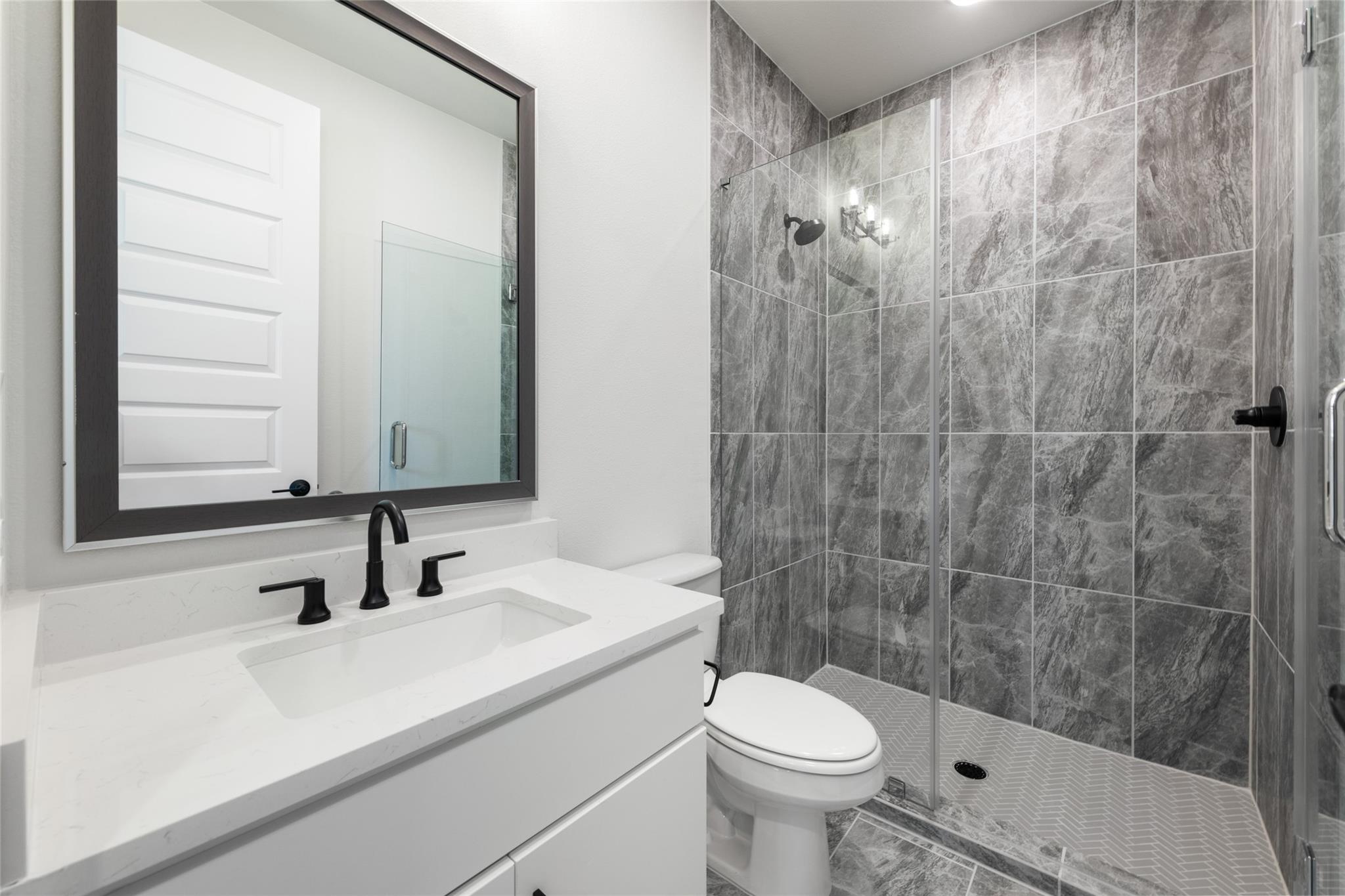 6216 Bower Well Road Austin, TX 78738 - Photo 15 of 31 a bathroom with a sink a toilet and shower