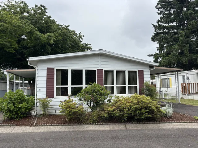 a view of a house with a yard and sitting area