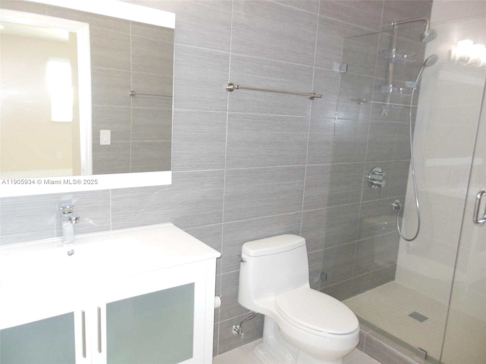 2280 Southwest 32nd Avenue, Unit 406 Miami, FL 33145 - Photo 5 of 8 a bathroom with a sink toilet and shower